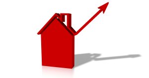 rotes 3D-Haus mit einem Pfeil der nach oben geht. Damit werden die steigenden Zinsen für Kreditnehmer symbolisiert.